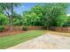 The home has a spacious backyard with a stone patio and a wood privacy fence at 508 Canton Ct, Canton, GA 30115