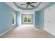 Large bedroom with tray ceiling and plush carpet, bathed in natural light at 508 Canton Ct, Canton, GA 30115