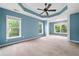 A bedroom that features large windows that let in natural light and a tray ceiling with fan at 508 Canton Ct, Canton, GA 30115