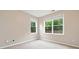 Neutral bedroom featuring two large windows offering views of the green backyard at 508 Canton Ct, Canton, GA 30115