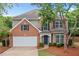Charming brick two-story home with a manicured lawn, two car garage and mature trees at 508 Canton Ct, Canton, GA 30115