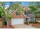 Charming brick-front home with a well-manicured lawn, two-car garage, and mature trees at 508 Canton Ct, Canton, GA 30115