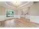 Spacious living room with a large window, beautiful wainscoting and modern floors at 508 Canton Ct, Canton, GA 30115