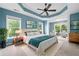 A beautifully staged bedroom with a tray ceiling, complete with decor and ample natural light at 508 Canton Ct, Canton, GA 30115