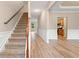 Open staircase with carpeted steps and views of the entry and kitchen at 508 Canton Ct, Canton, GA 30115