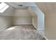 Large bedroom with skylight and plush carpet flooring, providing ample natural light at 1311 Bustling Sw Ln, Marietta, GA 30064