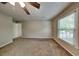 Bedroom featuring neutral paint, plush carpet, a ceiling fan, and bright natural light at 1311 Bustling Sw Ln, Marietta, GA 30064