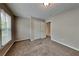 Bedroom with soft carpet flooring, bright lighting, and a window with blinds at 1311 Bustling Sw Ln, Marietta, GA 30064