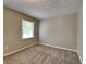 Cozy bedroom featuring neutral paint, plush carpet, and bright natural light at 1311 Bustling Sw Ln, Marietta, GA 30064