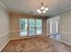 Open-concept dining area featuring neutral paint, large windows with natural light, and contemporary lighting at 1311 Bustling Sw Ln, Marietta, GA 30064