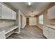 Open kitchen featuring white cabinets, granite countertops, and modern wood-look flooring at 1311 Bustling Sw Ln, Marietta, GA 30064