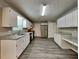 Spacious kitchen featuring sleek stainless steel appliances and ample counter space and modern wood-look flooring at 1311 Bustling Sw Ln, Marietta, GA 30064