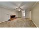 Spacious living room with classic brick fireplace, neutral paint, and ceiling fan at 1311 Bustling Sw Ln, Marietta, GA 30064