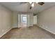 Bedroom featuring neutral paint, plush carpet, a ceiling fan, and ensuite bath with natural light at 1311 Bustling Sw Ln, Marietta, GA 30064