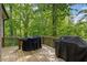 Wooden back deck with covered grills; wooded area in the background at 1686 Brooks Farm Nw Dr, Acworth, GA 30101