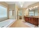 Bright bathroom featuring a garden tub, dual sinks, and a vanity with granite countertops at 1686 Brooks Farm Nw Dr, Acworth, GA 30101