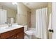 Bathroom with shower over tub, neutral tile and a dark wood vanity cabinet at 1686 Brooks Farm Nw Dr, Acworth, GA 30101
