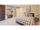 Comfortable bedroom with grey-toned bedding, a sliding barn door and view to exercise equipment at 1686 Brooks Farm Nw Dr, Acworth, GA 30101