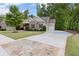 Beautifully landscaped home featuring a long driveway leading to a two car garage at 1686 Brooks Farm Nw Dr, Acworth, GA 30101