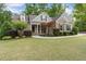 Charming stone and siding home with manicured lawn and landscaping at 1686 Brooks Farm Nw Dr, Acworth, GA 30101