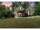 Charming stone and siding home with manicured lawn and landscaping at 1686 Brooks Farm Nw Dr, Acworth, GA 30101