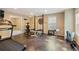 Bright home gym with weight training equipment and a treadmill on stained concrete floors at 1686 Brooks Farm Nw Dr, Acworth, GA 30101