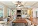 Open living room featuring stone fireplace, a ceiling fan, and hardwood floors at 1686 Brooks Farm Nw Dr, Acworth, GA 30101