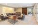 Spacious finished basement living room with large sofa and sliding barn door at 1686 Brooks Farm Nw Dr, Acworth, GA 30101