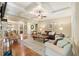 Open-concept living room with hardwood floors, fireplace and a view of the dining room at 1686 Brooks Farm Nw Dr, Acworth, GA 30101