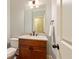 Charming powder room with granite countertop, updated vanity, mirror and tile floors at 1686 Brooks Farm Nw Dr, Acworth, GA 30101