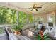Cozy screened-in porch with wooded views and comfortable seating arrangement at 1686 Brooks Farm Nw Dr, Acworth, GA 30101