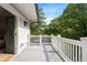 Open-air balcony features gray decking, a white railing, and an open door to the main bedroom at 364 Glendale Ne Ave # B, Atlanta, GA 30307