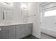 Stylish bathroom featuring double vanity with gray cabinets, white countertop, and shower with subway tile at 364 Glendale Ne Ave # B, Atlanta, GA 30307