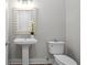 Elegant powder room featuring a pedestal sink, decorative mirror, and stylish lighting at 364 Glendale Ne Ave # B, Atlanta, GA 30307