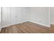 Bedroom featuring hardwood floors, base trim and a large, mirrored closet door for ample storage at 364 Glendale Ne Ave # B, Atlanta, GA 30307