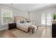 Sunlit bedroom with hardwood floors, French doors, a neutral color scheme, and carpet at 364 Glendale Ne Ave # B, Atlanta, GA 30307