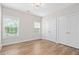 Bedroom featuring hardwood floors and a large, mirrored closet door, illuminated by overhead lighting at 364 Glendale Ne Ave # B, Atlanta, GA 30307