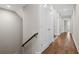 Hallway with hardwood floors, white walls, and a stairway with wood handrail at 364 Glendale Ne Ave # B, Atlanta, GA 30307