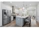 Bright, modern kitchen with white cabinets, gray island, stainless steel appliances, and hardwood floors at 364 Glendale Ne Ave # B, Atlanta, GA 30307