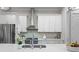 Modern kitchen featuring white cabinets, stainless steel appliances, tile backsplash, and quartz countertops at 364 Glendale Ne Ave # B, Atlanta, GA 30307