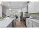 Bright, modern kitchen with white cabinets, gray island, stainless steel appliances, and hardwood floors at 364 Glendale Ne Ave # B, Atlanta, GA 30307