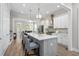 Bright, modern kitchen with white cabinets, gray island, stainless steel appliances, and hardwood floors at 364 Glendale Ne Ave # B, Atlanta, GA 30307