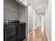Bright laundry room showcasing modern, black washer and dryer with wood floors and white walls at 364 Glendale Ne Ave # B, Atlanta, GA 30307
