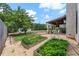 Large backyard with a covered patio, garden beds, and mature trees, creating a private outdoor retreat at 944 Hidden Falls Se Ln, Smyrna, GA 30082