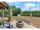 Inviting backyard featuring a fire pit and patio with outdoor seating, perfect for relaxation and entertaining at 944 Hidden Falls Se Ln, Smyrna, GA 30082