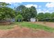 Green backyard with a swing set and garden shed that is perfect for Gathering time and outdoor activities at 944 Hidden Falls Se Ln, Smyrna, GA 30082