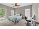 Bedroom with a bed, desk, and large windows overlooking the outside scenery at 944 Hidden Falls Se Ln, Smyrna, GA 30082