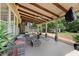 Spacious covered patio with comfortable seating, TV, and ceiling fans, offering a relaxing outdoor living space at 944 Hidden Falls Se Ln, Smyrna, GA 30082