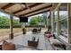 Relaxing covered patio with comfortable seating, a TV, and ceiling fans, perfect for outdoor enjoyment at 944 Hidden Falls Se Ln, Smyrna, GA 30082