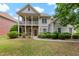 Charming two-story home with a welcoming front porch, stone accents, and lush landscaping at 944 Hidden Falls Se Ln, Smyrna, GA 30082